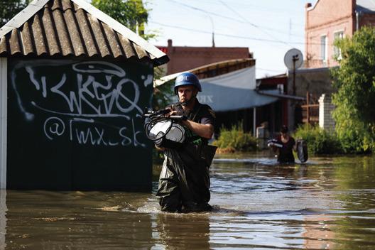 A RESCUER helps to save belongings of locals from flooding following the destruction of the Kakhovka dam, on June 7, 2023, in Kherson, Ukraine. Early Tuesday, the Kakhovka dam and hydroelectric power plant, which sit on the Dnipro river in the southern Kherson region, were destroyed, forcing downstream communities to evacuate do to risk of flooding. (Alex Babenko/ Getty Images/TNS)