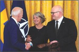 President Joe Biden, left, greets Ambassadors Karin Ulrika Olofsdotter of Sweden, center, and Mikko Hautala of Finland after signing the Instruments of Ratification for the NATO Accession Protocols for Finland and Sweden in the East Room at the White House in Washington, D.C., on Tuesday, Aug. 9, 2022. (Yuri Gripas/Abaca Press/TNS)