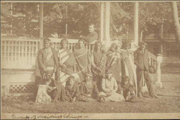 STUDENTS WHO have just arrived at the Carlisle Indian Industrial School pose with veteran students near a pavilion. Photo from the Carlisle Indian School Digital Resource Center.