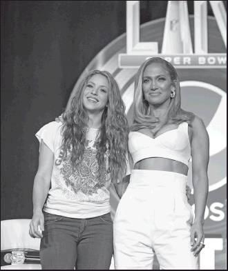 NFL SUPER BOWL 54 football game halftime performers Jennifer Lopez, right, and Shakira pose for a picture after a news conference Thursday in Miami. (AP Photo)